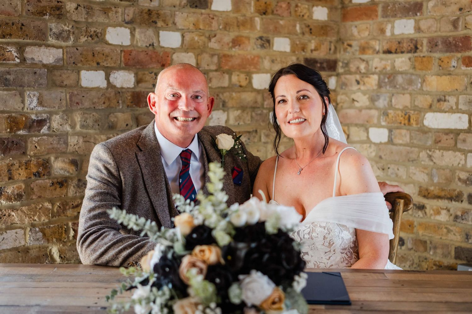 bride and groom sign the register