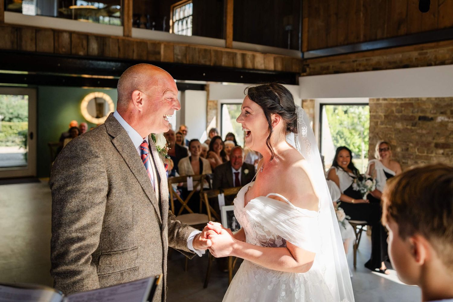 bride and groom laugh during wedding ceremony at chapel house estate in minster ramsgate Kent