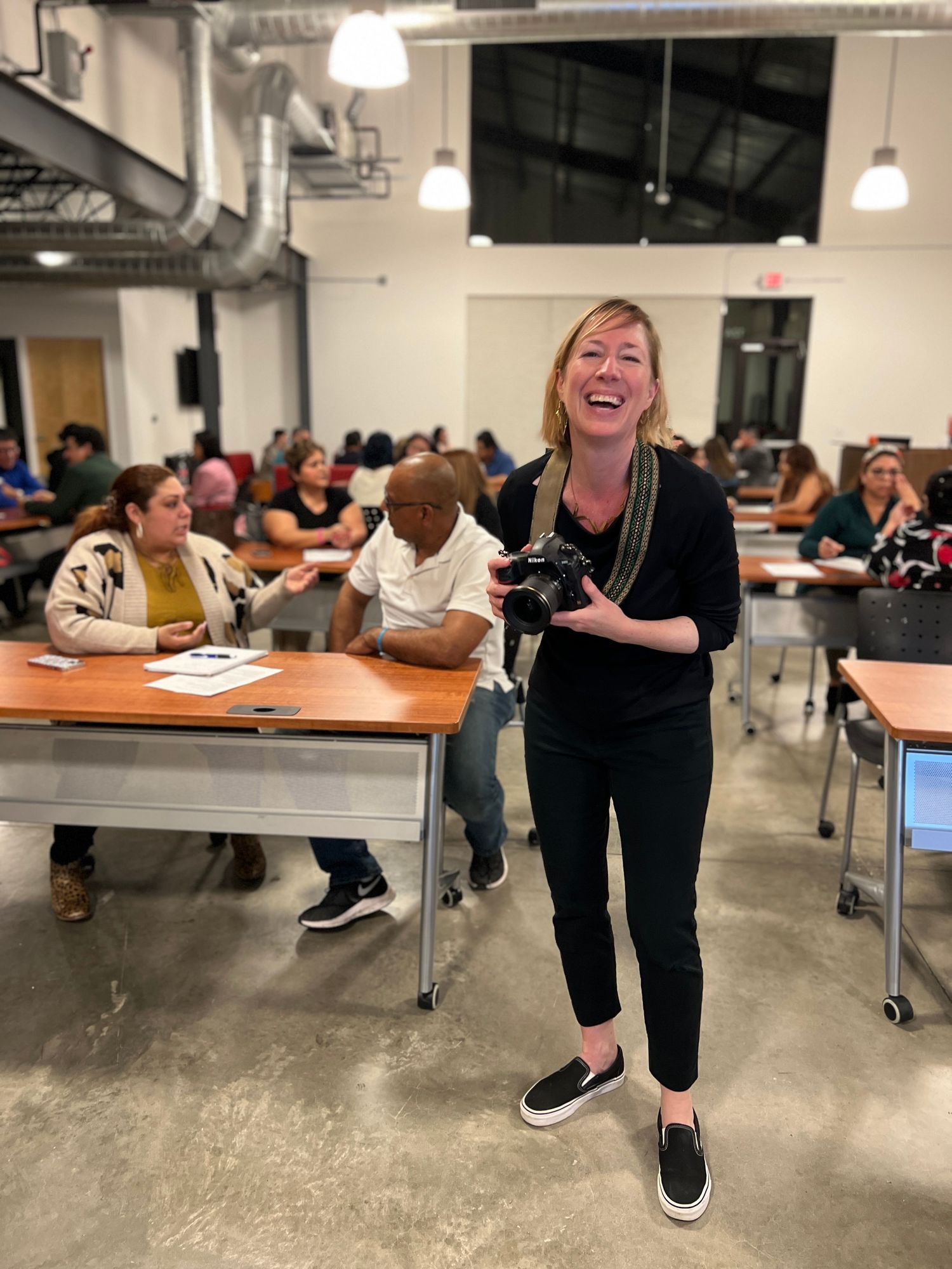 A sequence of photos showing someone progressively falling over while laughing in a classroom or office setting.