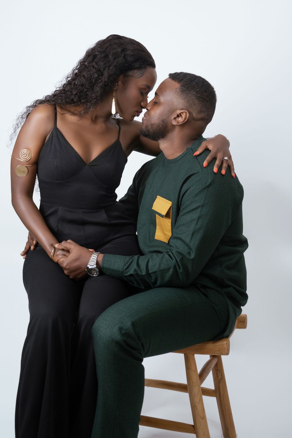 Intimate studio portrait of couple in formal wear sharing tender moment.
