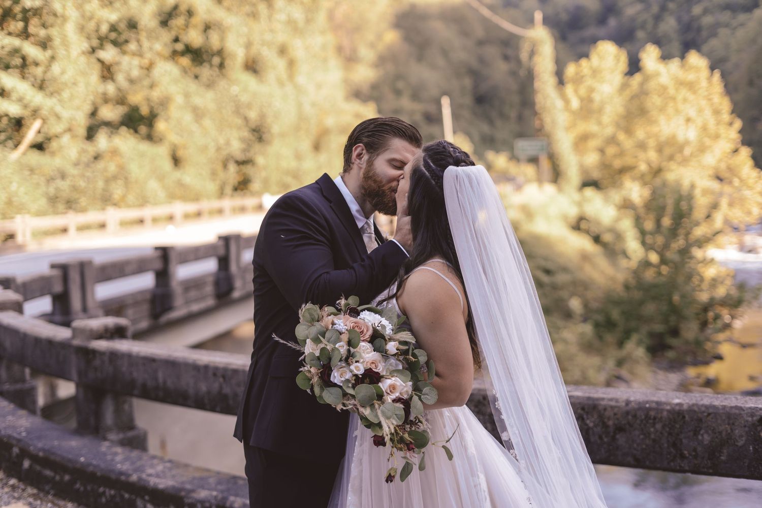Bride and groom kissing during first look at Tapoco Lodge in Robbinsville, NC