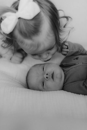 A series of black and white portraits showing peaceful expressions in soft lighting.