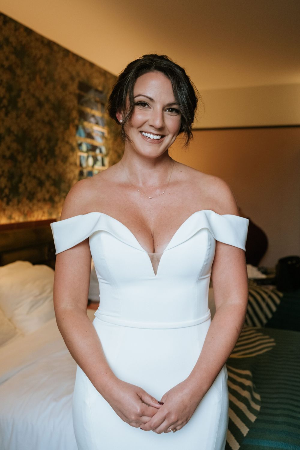 Elegant white off-shoulder wedding dress with fitted bodice.
