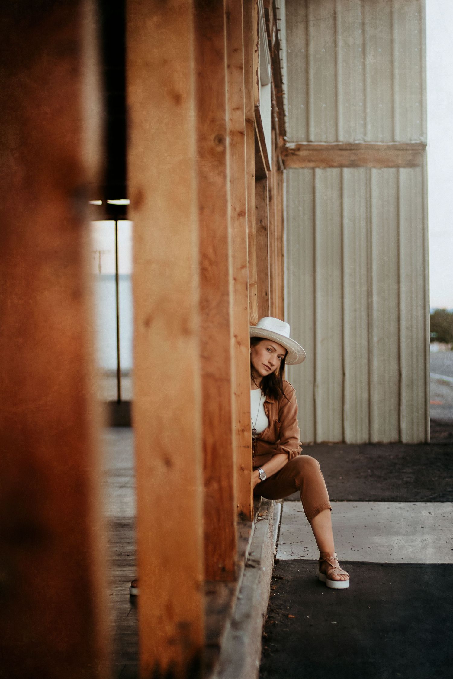 Alicia Alvey, Reno-based lifestyle and wedding photographer, smiling casually while seated outdoors in a relaxed, natural setting.