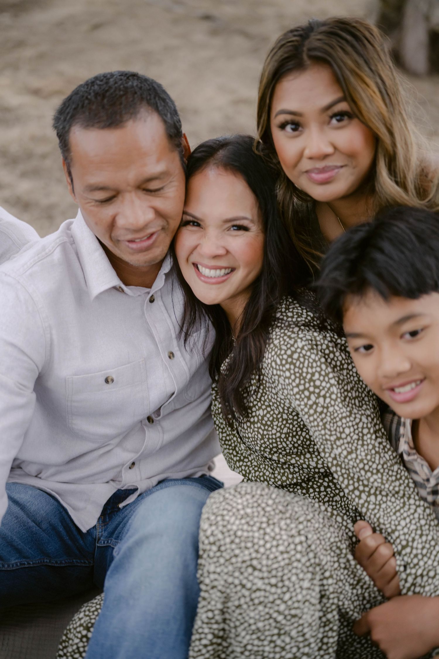 A loving family poses together outdoors for a heartwarming portrait.