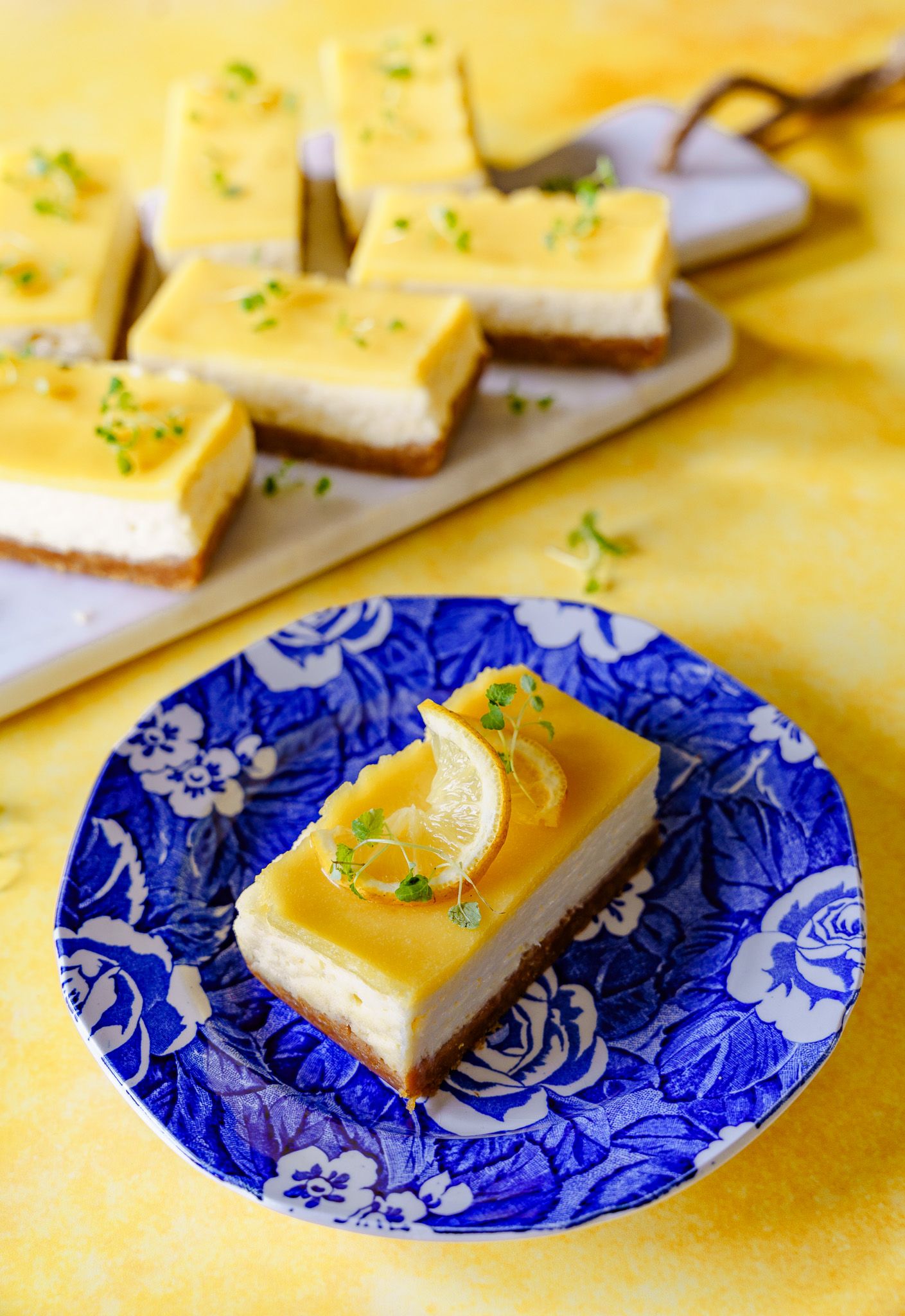 cheesecake slices styled on board and decorative plate with food props for food photography for website