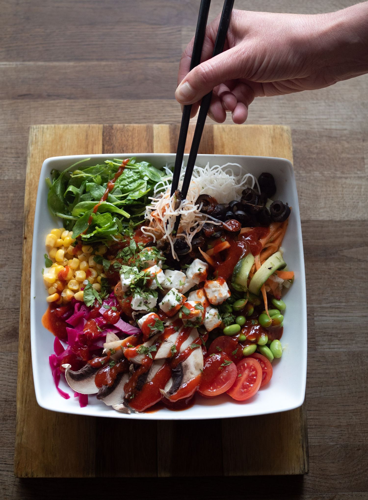 hand in shot of ramen bowl food photography for restaurant