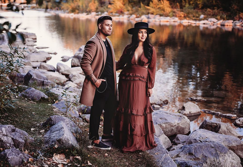 Man and woman dressed up fancy looking out onto the water at Princes Island Park,Calgary, Alberta