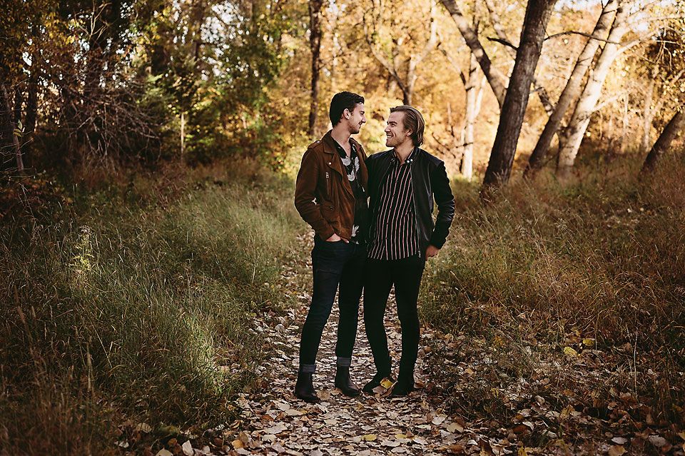 Gay male couple looking at each other at Pearce Estate Park, Calgary, Alberta