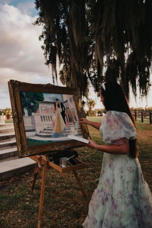 Plein air painting session capturing white stone architecture under moody skies.