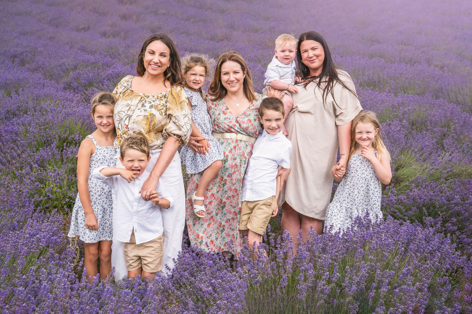 Family of 9 for an outdoor photoshoot during summer, dressed in off-whites and delicate florals