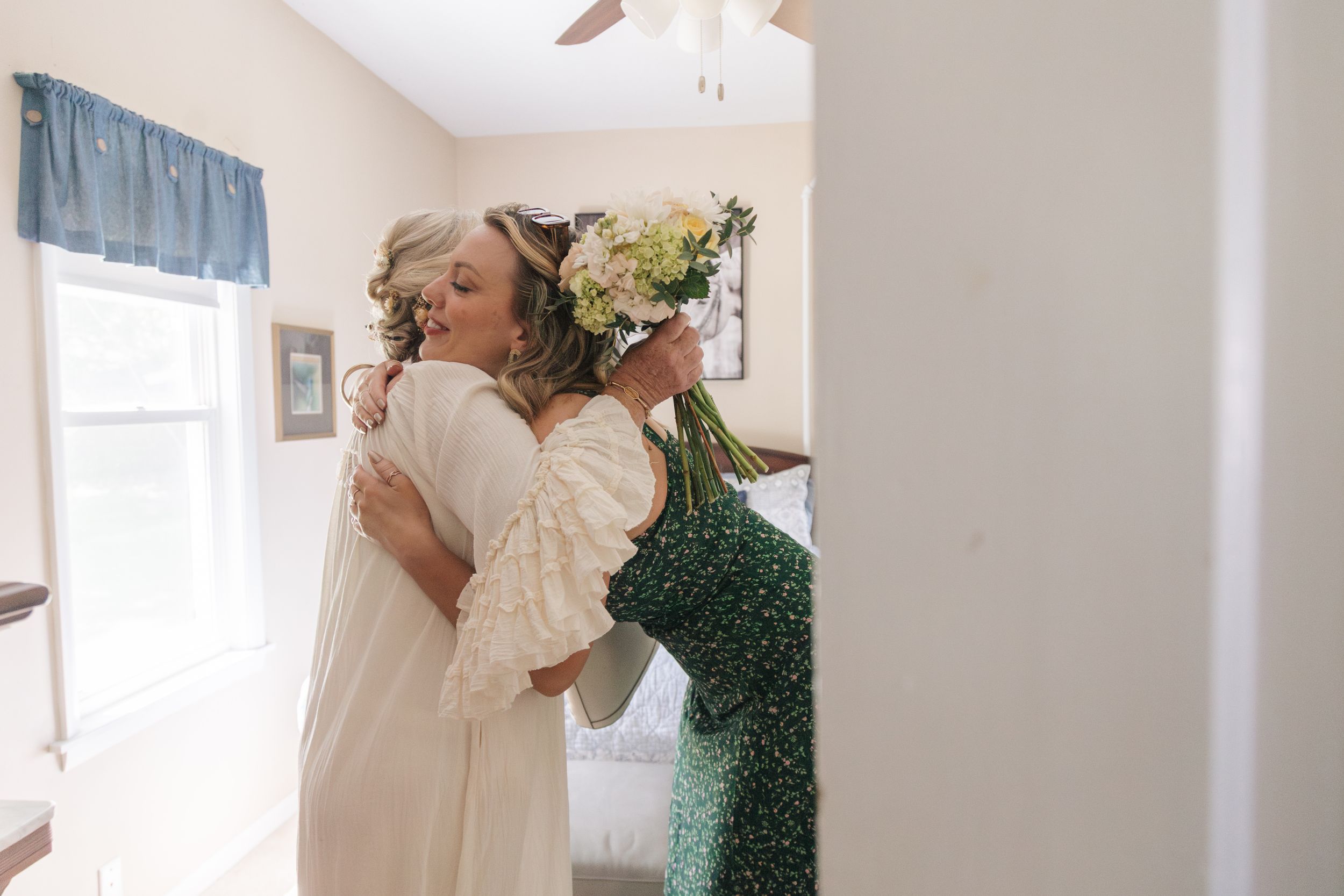 Bride and daughter hug