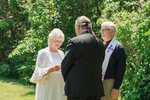 Exchanging wedding vows in an outdoor ceremony
