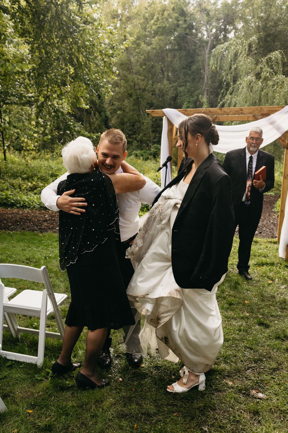 A series of candid wedding photos showing a couple sharing playful moments and laughter on white chairs in a garden setting.