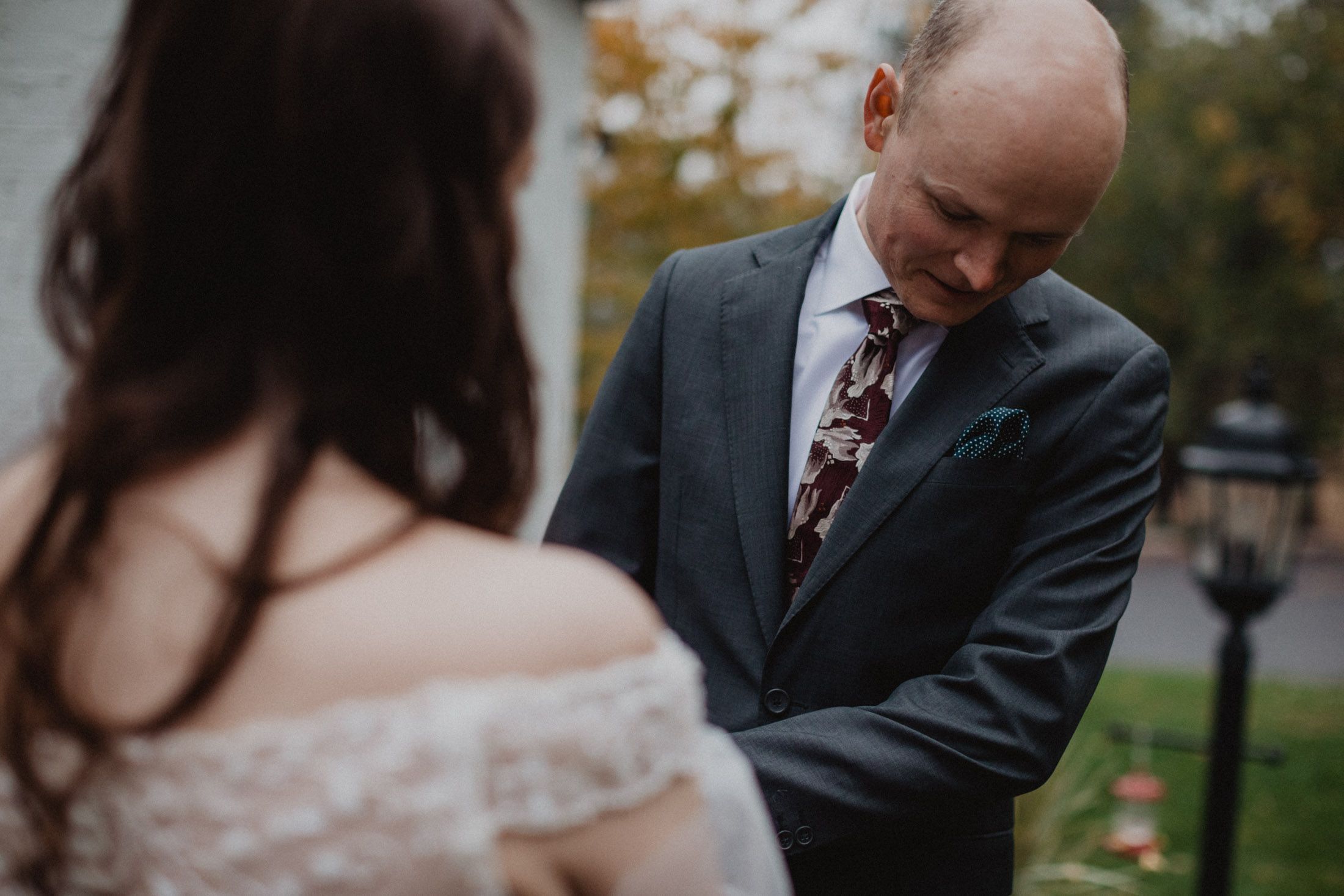 A series of candid wedding moments captured outdoors with autumn foliage in the background.