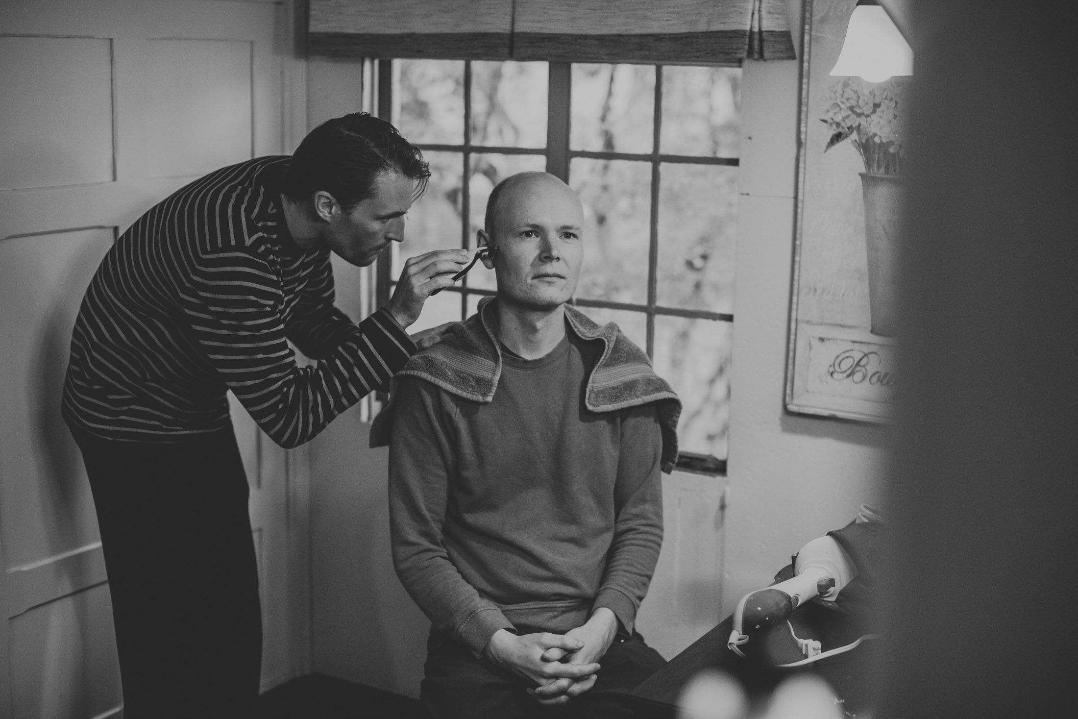 A series of black and white photos showing people in conversation and interaction in what appears to be an office setting.