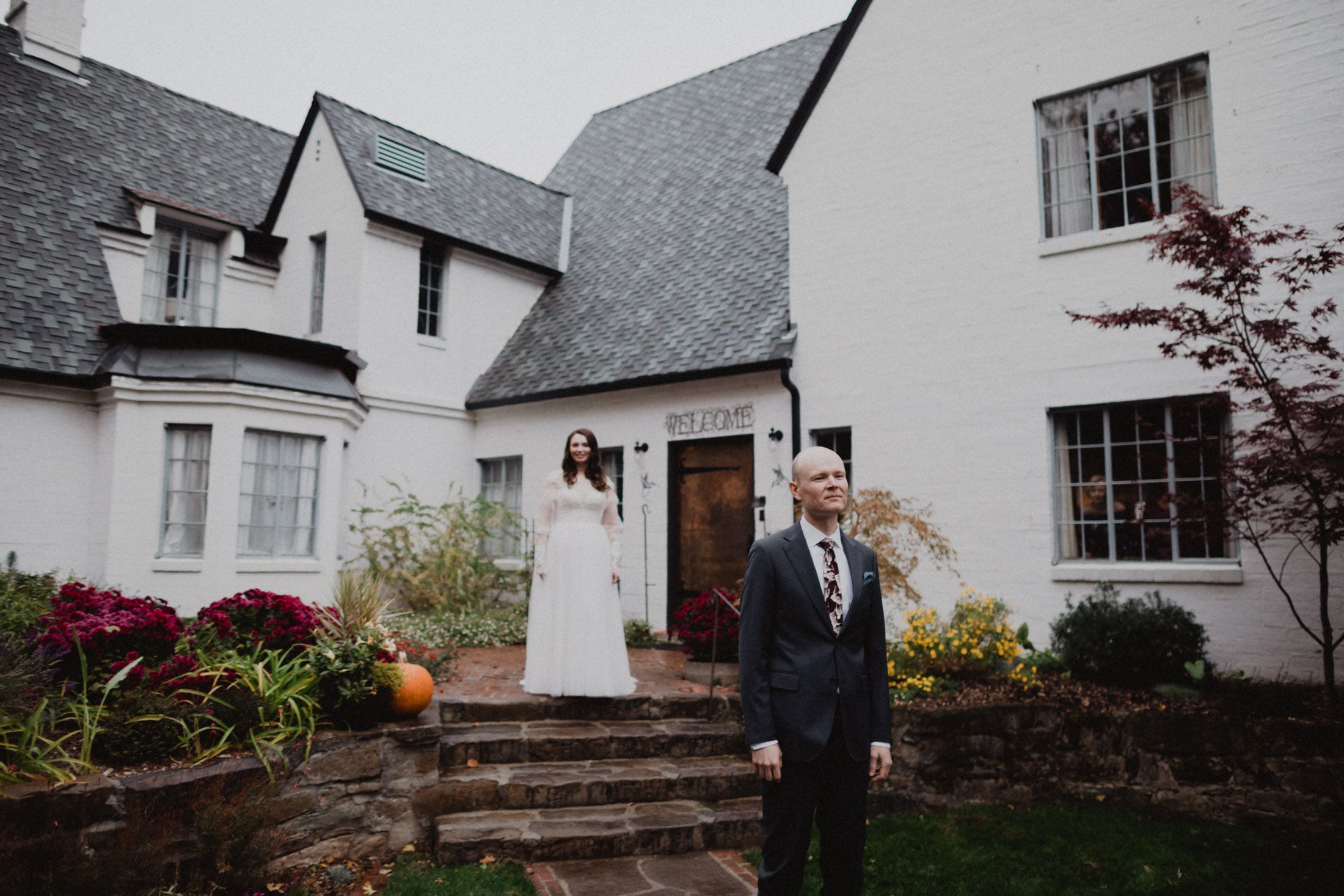A black and white photo collage showing outdoor wedding moments at a white house with architectural details.