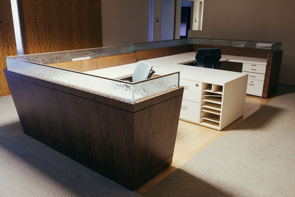 Modern office reception area with dark wood counters and built-in storage.