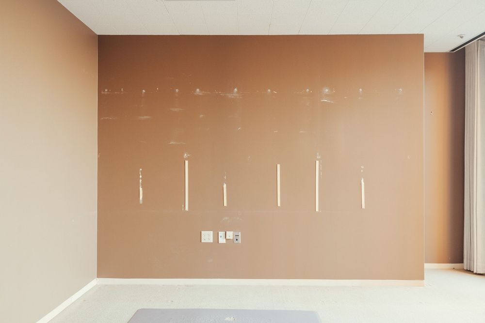 Empty beige hallway with minimalist design and recessed lighting.