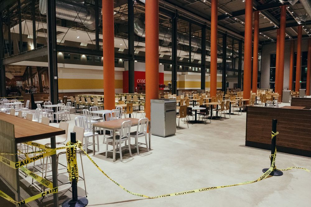 Large cafeteria space with orange support columns and scattered seating areas.