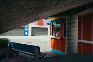 Concrete architectural detail with colorful accent walls and geometric shapes.