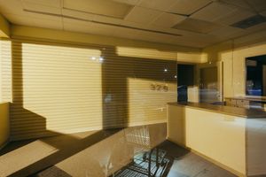 Underground parking area with yellow walls and fluorescent lighting.