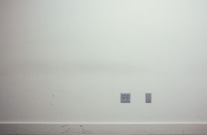 Clean white wall with electrical outlets mounted near the baseboard.