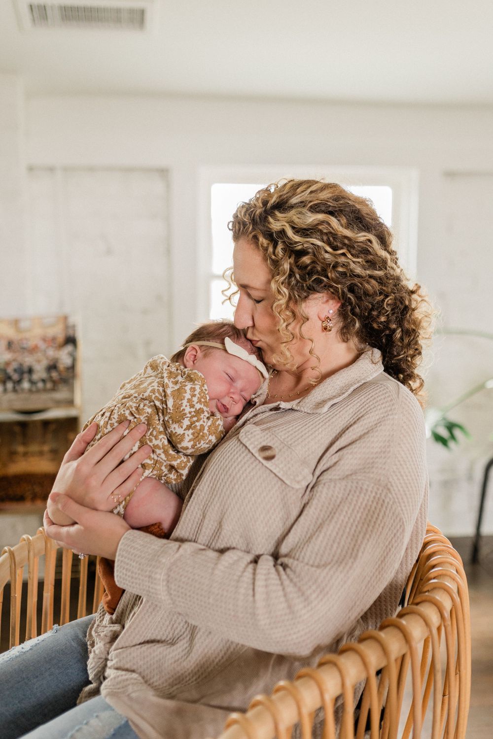 A tender family moment captured in a bright room with wooden furniture.