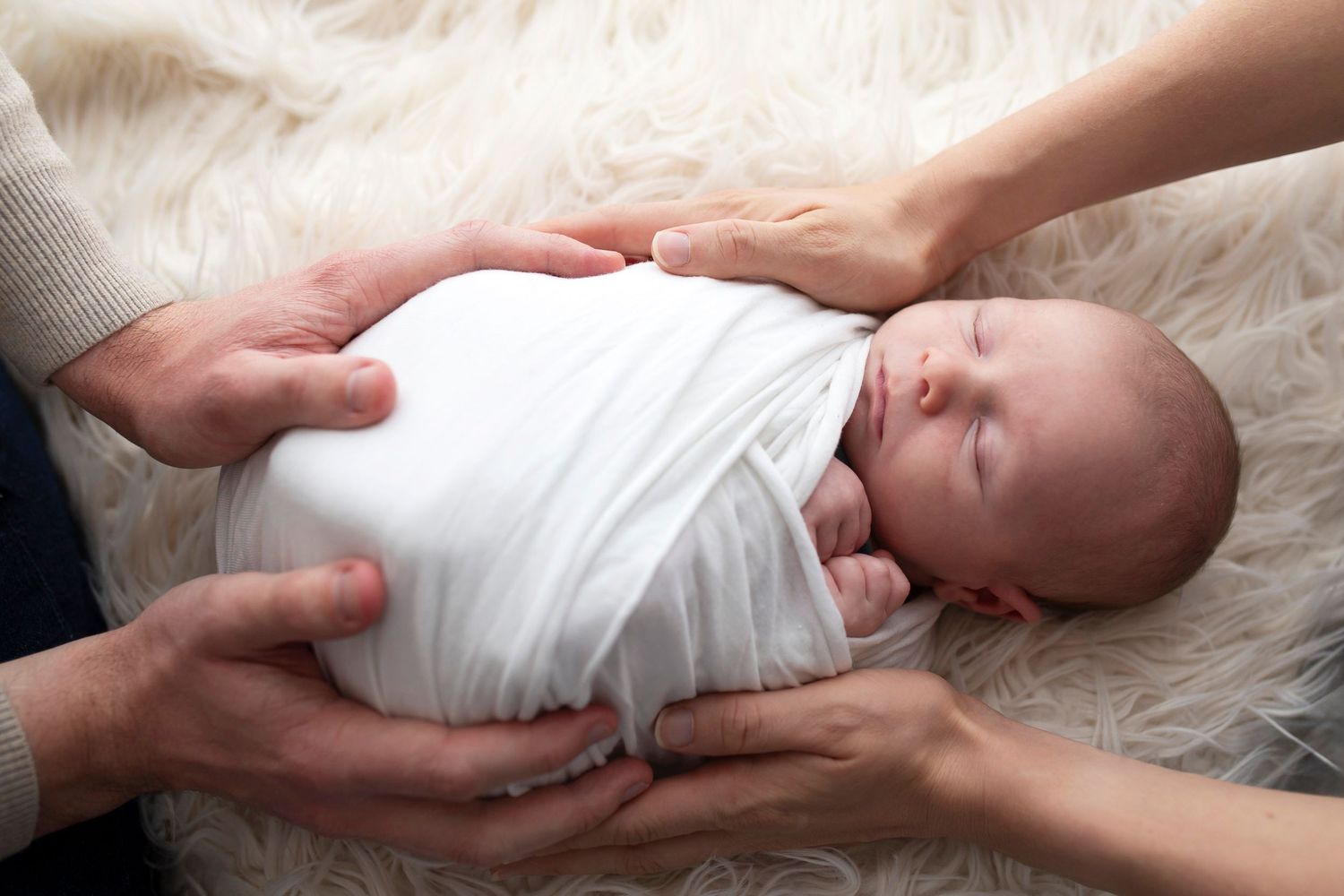 parents hands newborn baby girl by little wonderland photography widnes cheshire