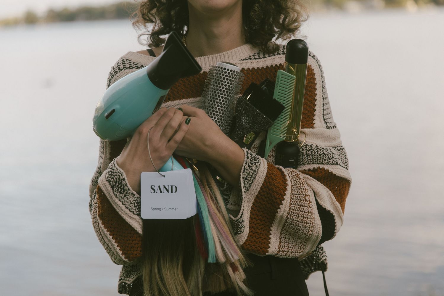 A Michigan hairstylist holding some of her tools for branding photos taken by Richelle Healy Photo.