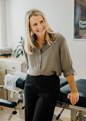 Healthcare professional in medical office demonstrates proper posture and positioning during consultation.
