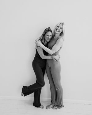 A black and white series showing two people embracing in various poses against a plain backdrop.