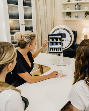 Two people examining diagnostic images on a screen in a medical consultation room.