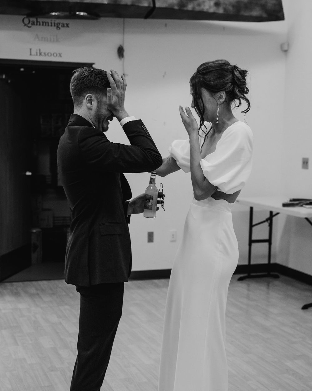 Black and white photo of bride and groom sharing a tender moment on the dance floor at their wedding reception.