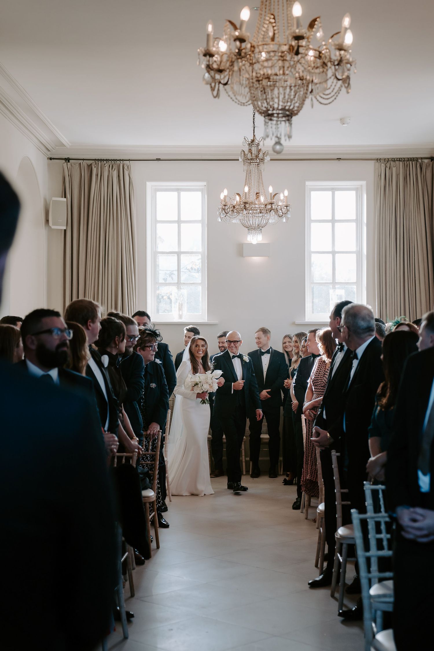bride and dad walking down the aisle to the groom waiting at the alter at Iscoyd park