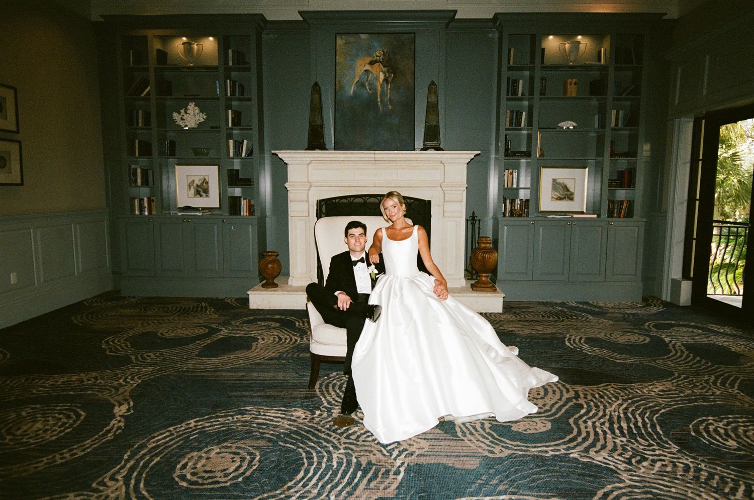 An elegant winter wedding reception features romantic white floral decor and candlelight in a grand venue setting.