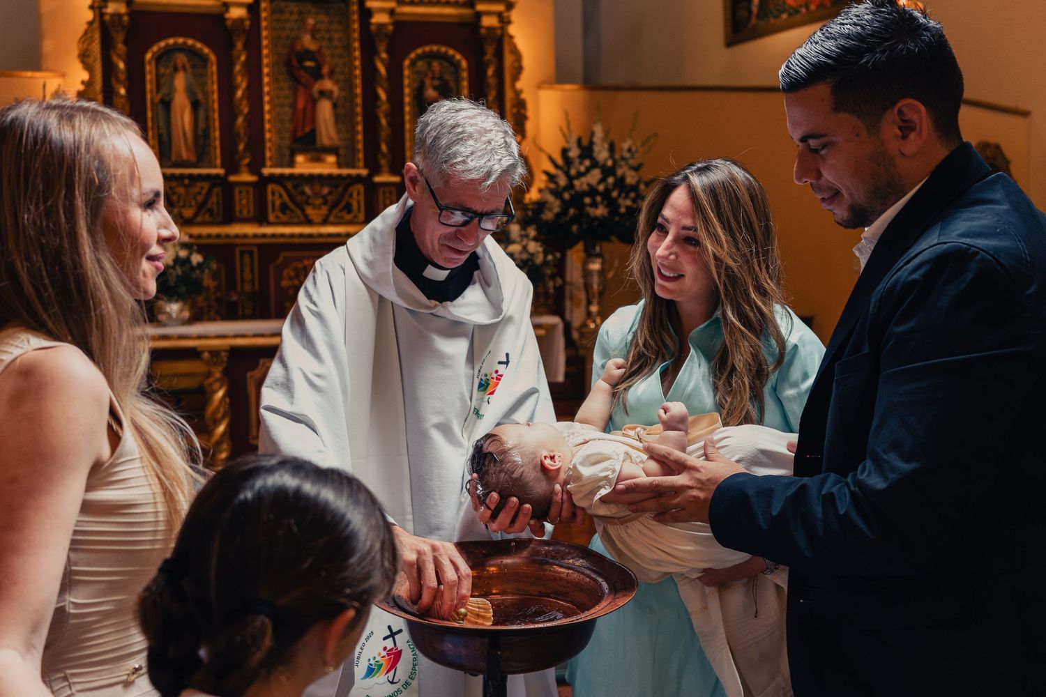 Several people gather in a church or chapel setting for what appears to be a religious ceremony or service.
