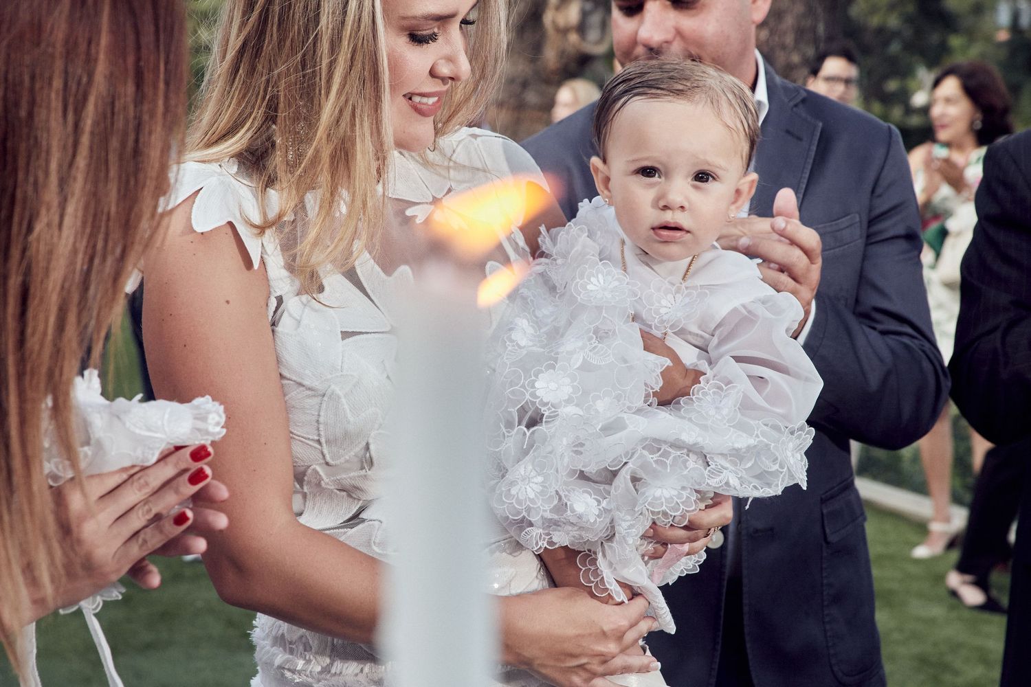 A group of people at an outdoor wedding celebration holding sparklers that create a magical glowing effect in the evening.
