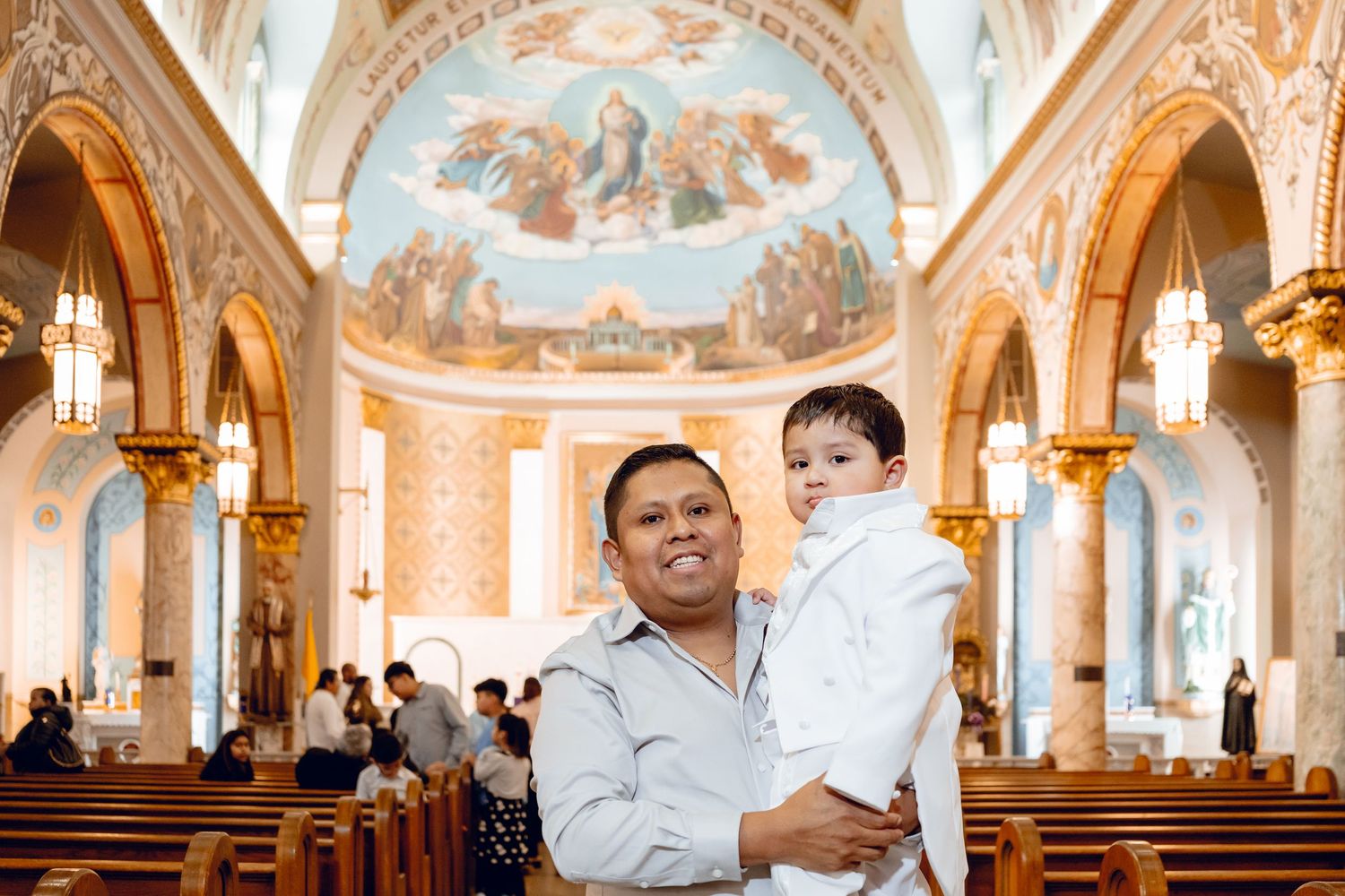 A panoramic view of an ornate church interior with vaulted ceilings, frescoes, and decorative architecture.