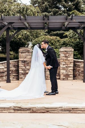 Couple kisses at their ceremony in Ypsilanti Michigan by Metro Detroit Wedding Photographer Rachel Martinez. Fine art wedding photography.