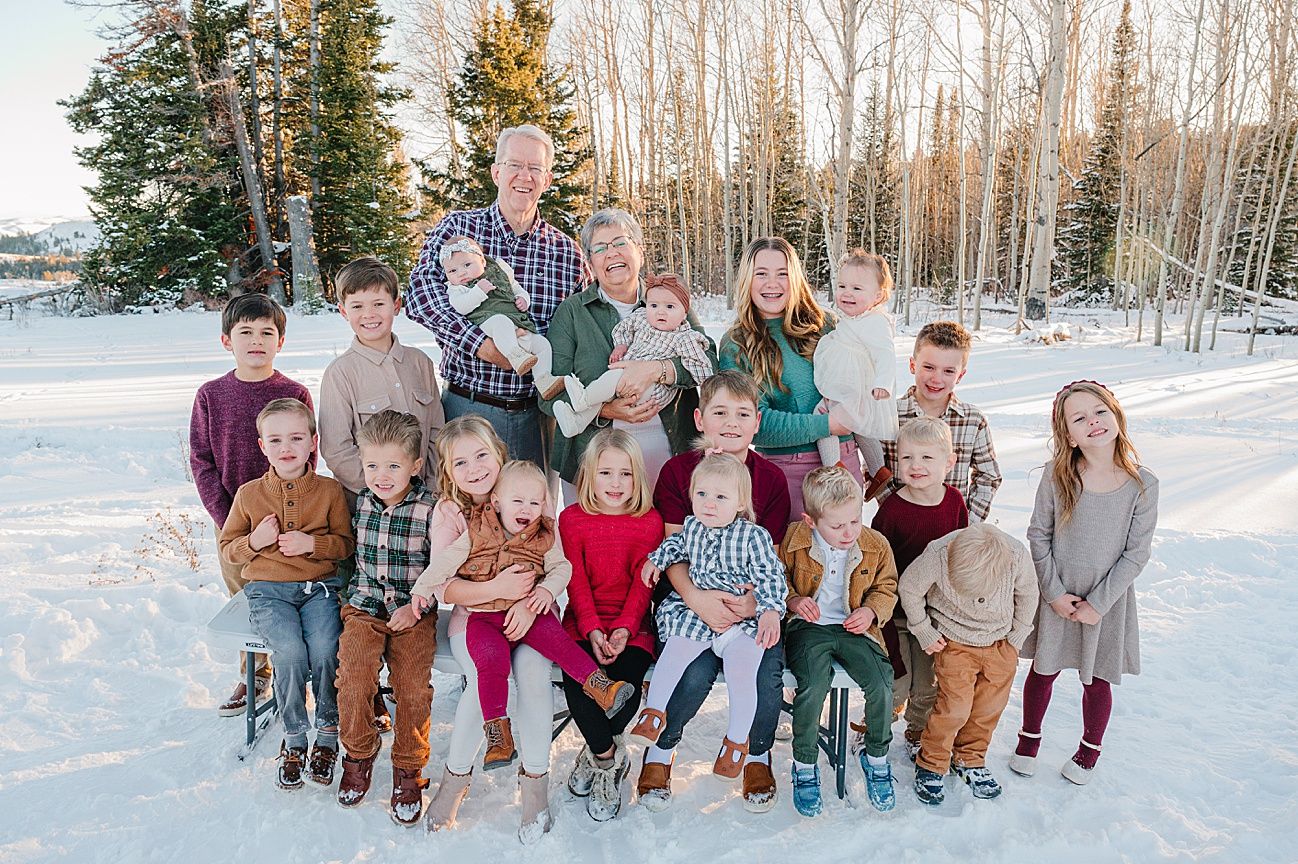 Group photo of people gathered on snowy slope with winter forest backdrop.