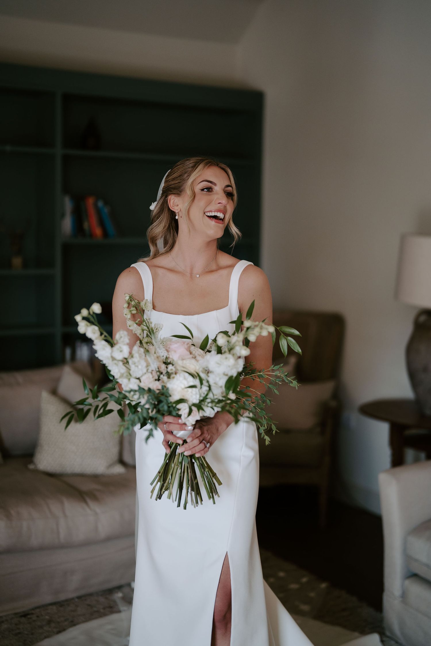 bride smiling holding bouquet at ivy lodge in cirencester