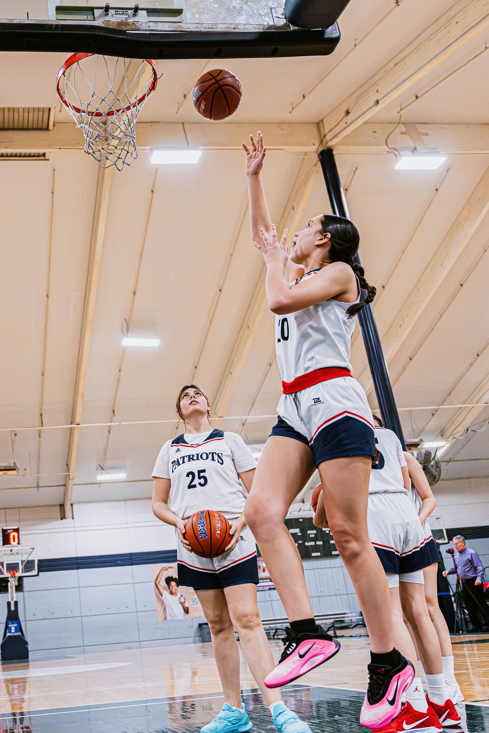 Girls Basketball player doing a layup