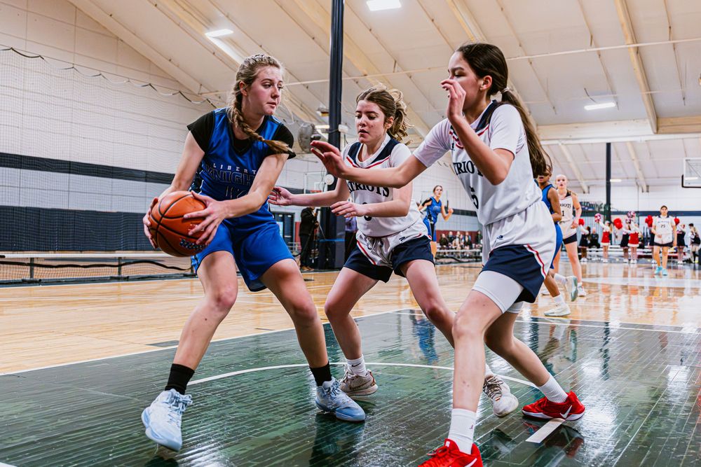 Girls Basketball players offending the offensive player
