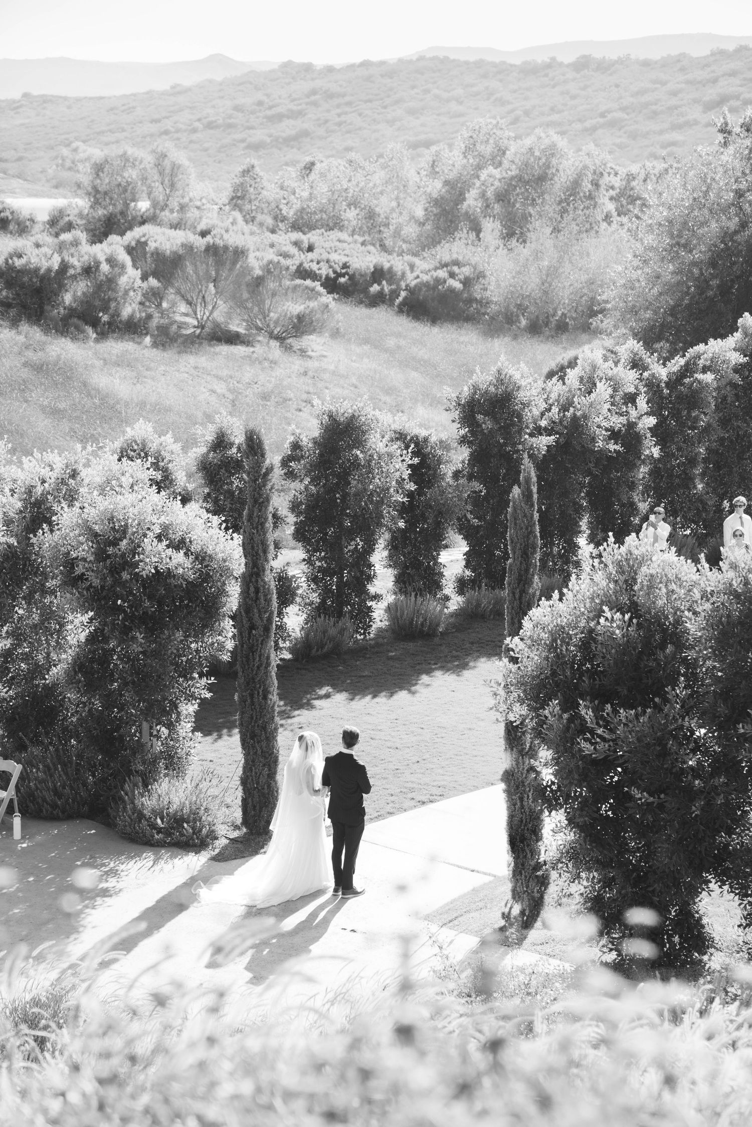 Bird's eye view of dad walking the bride down the aisle in San Diego California