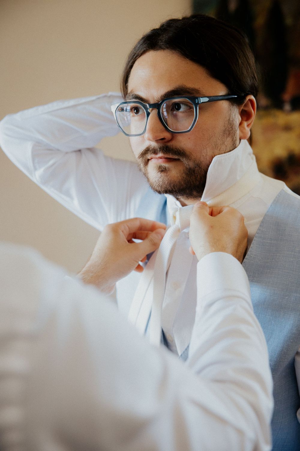 Close-up profile shots showing details of formal attire and glasses.