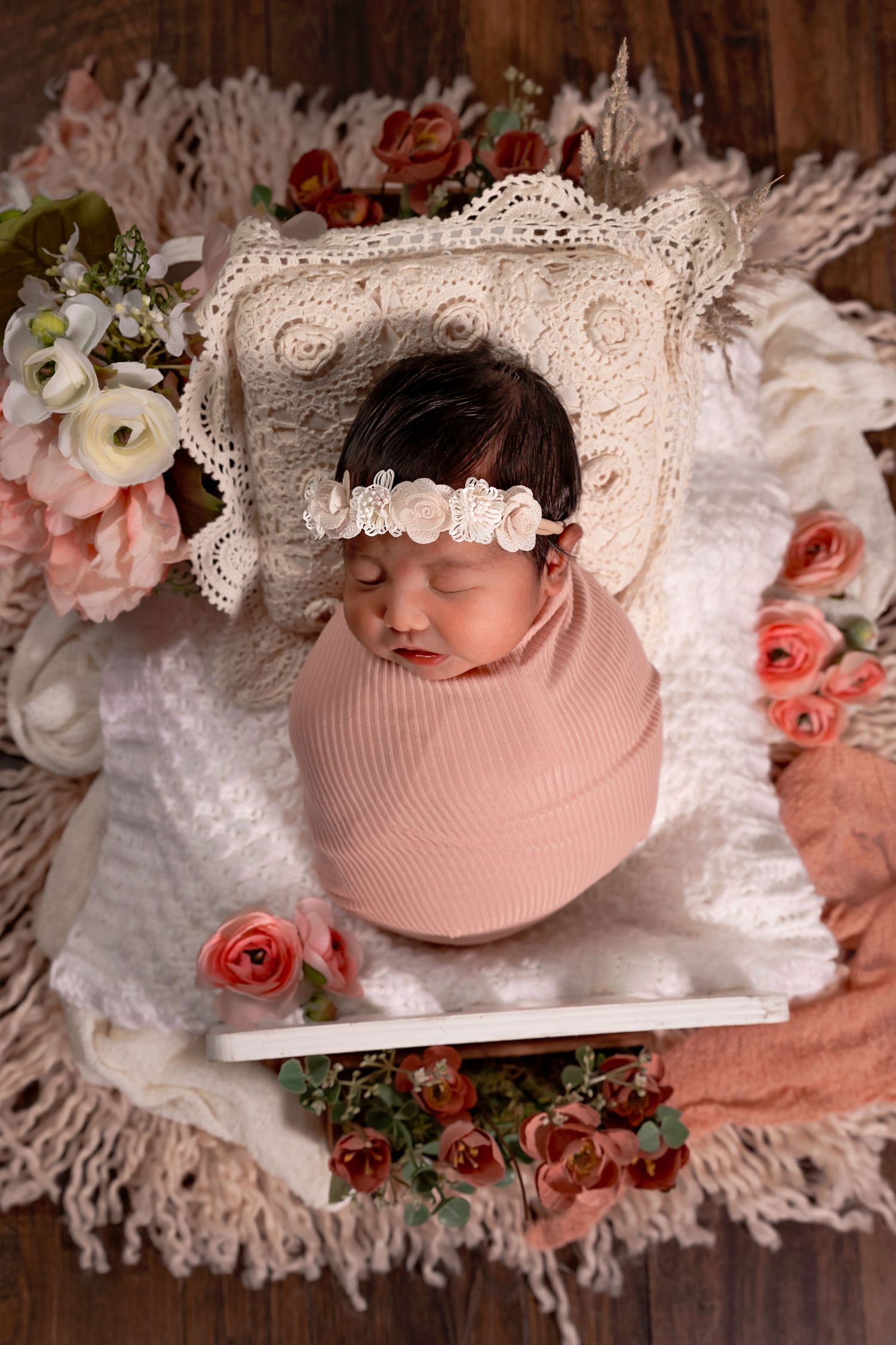 newborn baby captured in a beautiful set up with florals in northwest fresno studio colibri captures