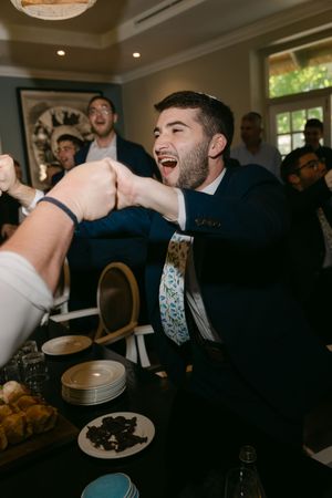 Wedding reception candid shots showing guests laughing and celebrating in an indoor venue.