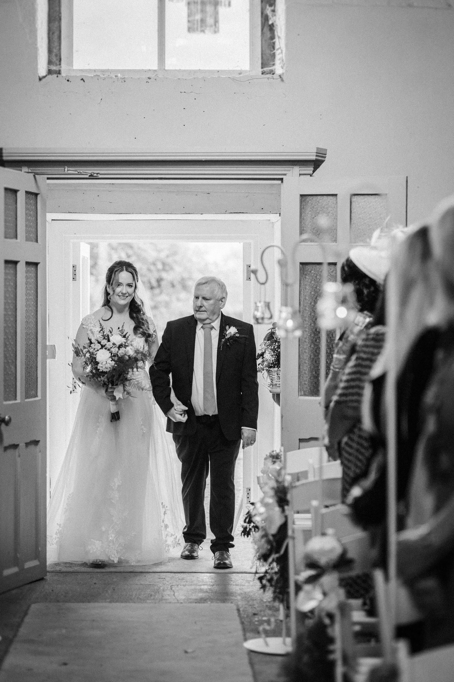 Black and white photo sequence of a wedding ceremony entrance in an elegant indoor venue.