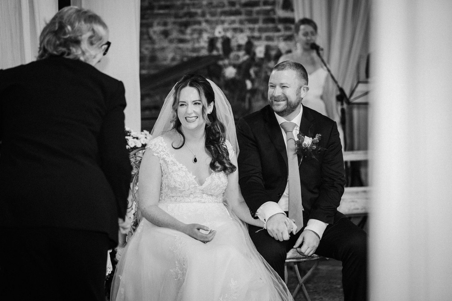 Black and white photo of a couple sharing their first dance at a wedding reception.